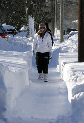 Here she comes just a walking down the street