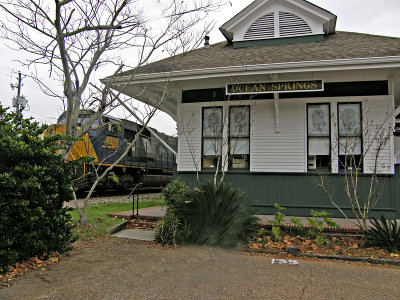 Ocean Springs, MS station with a passing train.