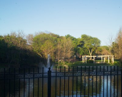 G W Bush's house backs onto the stream that is to the left of the fountain, several swan in the lake