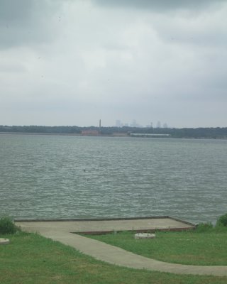 Small dock/platform with spillway and downtown Dallas in background