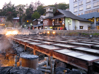 The hot water is cooled in the yubatake's wooden conduits before it's distributed to users.