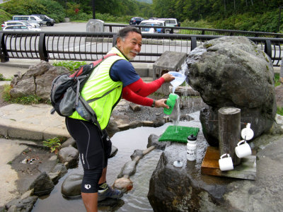 Day 25: Geno gets water for the day. Locals travel from afar to get this special water.