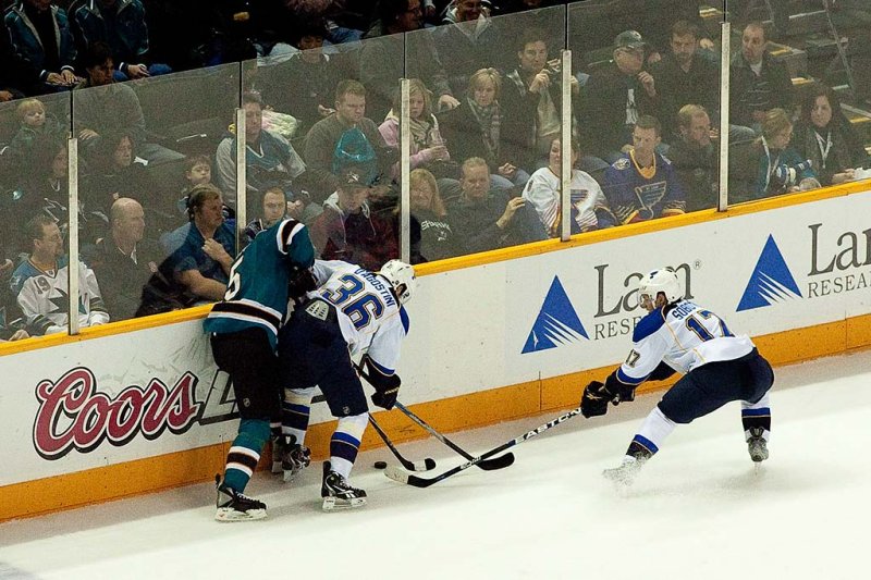 Dany Heatley fights for the puck with Matt D'Agostini and Vladimir Sobotka