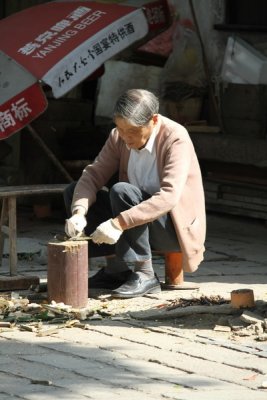 Old man chopping kindling