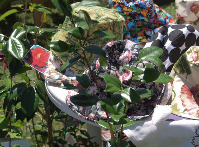 Hats and camellias for sale