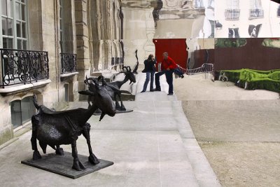 Malcolm and Carolyn with Picasso's Billy Goat reflected in a crazy outdoor mirror.jpg