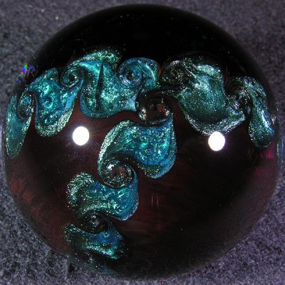 Gorgeous backside on this one, with sweet blue sparkle pinwheeling over top of a transparent deep ruby.