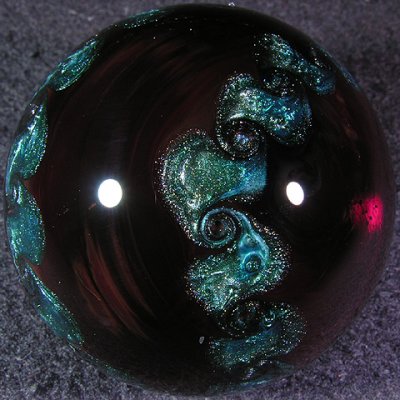 In hand with good light, the ruby looks much 'rubier', more like what you see on the right where the light is shining through.