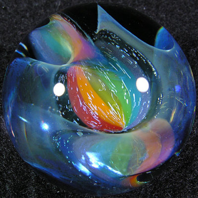 Kevin's special rainbow silver fume cane is twisted all through this marble.