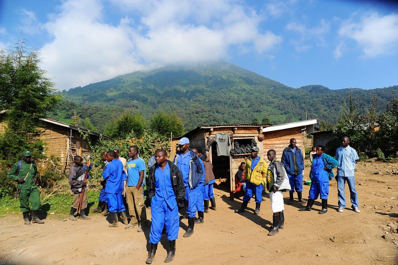 porters are ready to help,Bisoke mountain is on the background