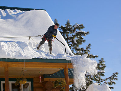 Jim Putnam shovels off roof