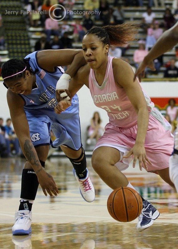 Yellow Jackets G Iasia Hemingway gets around a stumbling Tar Heels F Erlana Larkins