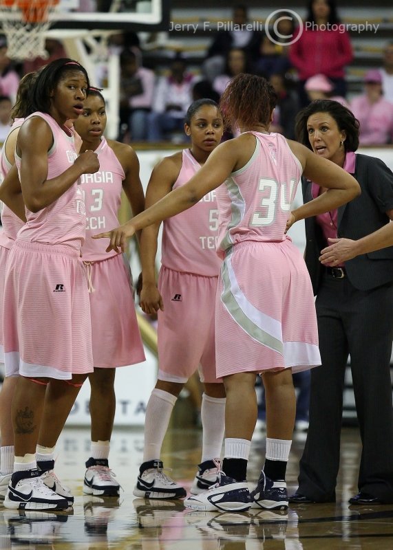 Jackets Head Coach Joseph huddles with the team during a 30 second timeout