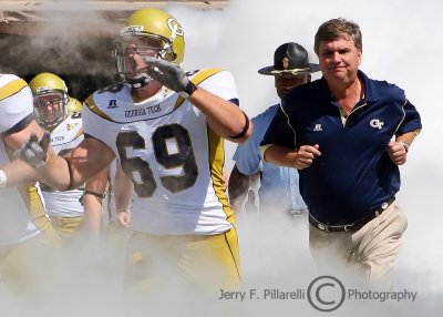Tech OL Alex Paquette runs interference for Head Coach Paul Johnson as the team takes the field