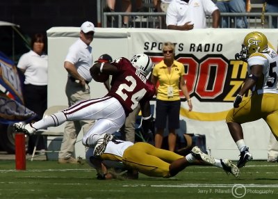 Jackets S Burnett trips up Bulldogs RB Anthony Dixon as he heads for the end zone