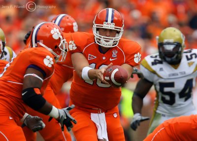 Clemson QB Cullen Harper hands off to a running back as GT LB Griffin fills a gap