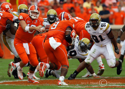 Tech DE Morgan lines up Tigers RB Jamie Harper as he takes a handoff from QB Cullen Harper