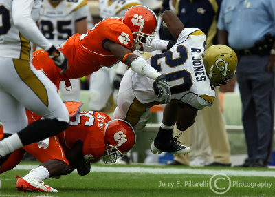 Jackets A-back Jones is brought down by Tigers CB Marcus Gilchrist and CB Maxwell