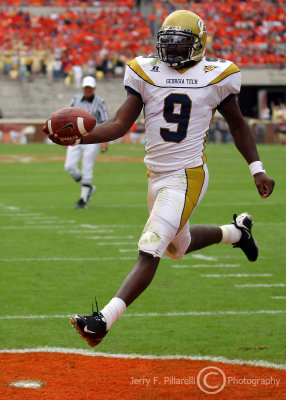 Jackets QB Nesbitt rolls around the right side for a touchdown just before the half