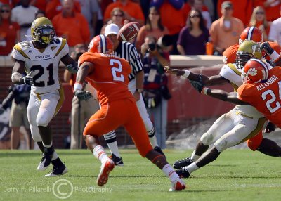 Jackets QB Nesbitt pitches to B-back Dwyer as hes hit by Tigers DE Kevin Alexander