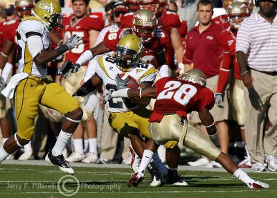 Jackets A-back Roddy Jones tries to avoid being tackled by Seminoles CB Dionte Allen