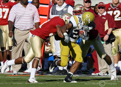 Georgia Tech A-back Jones gets tackled by Florida St. defenders after a big gain