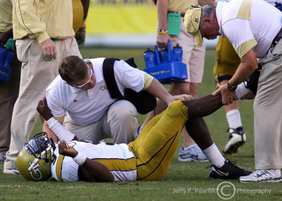 …Georgia Tech QB Nesbitt is attended to by the Tech medical staff