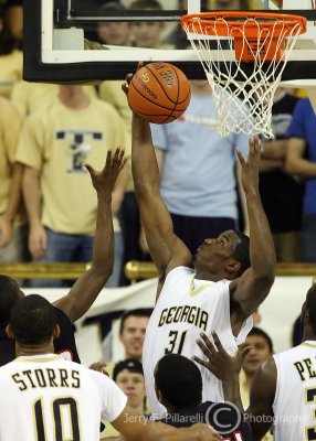 Jackets F Gani Lawal gets up to pull down a defensive rebound