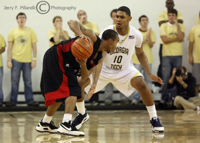 Yellow Jackets G Lance Storrs readies himself for the next move by Rams G Jemarcus McClinton