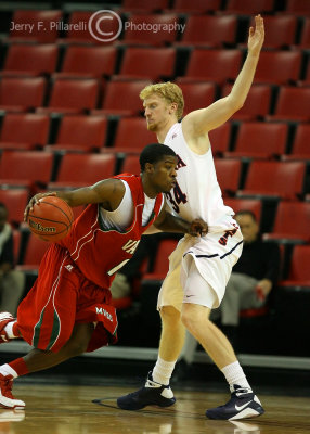 Wildcats F Budinger moves to get in front of driving MVS G Dwayne Harmason