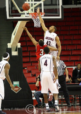 Cats F Horne gets up over the rim to defend the drive by Devils G Tashan Newsome