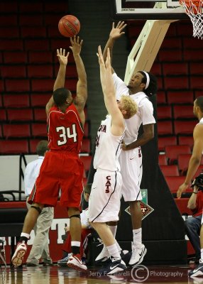 Wildcats F Budinger and F Hill defend a shot by Mississippi Valley State F Petty