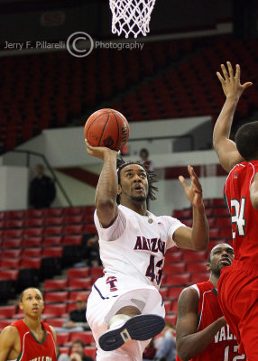 Arizona F Hill concentrates on his shot after the defender glides by