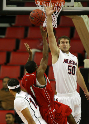 Wildcats C Alex Jacobson gets up to attempt to block a shot by Delta Devils G Harmason