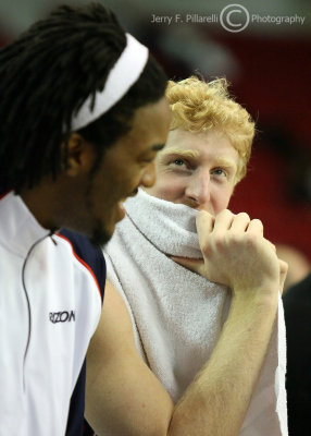Arizona F Jordan Hill and F Chase Budinger share a light moment on the bench as the game winds down