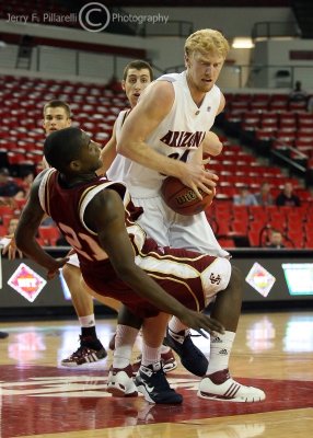 Cats F Budinger gets called for a charge as Broncos G Foster falls to the court after contact