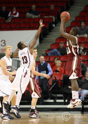 Cats G Wise gets a hand up to try to disrupt the deep last second three point shot by Broncos G Foster