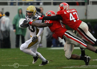 Yellow Jackets WR Andrew Smith is brought down by Bulldogs SLB Akeem Dent and SS Andrew Williams