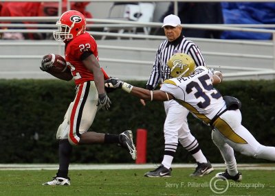 Jackets CB Michael Peterson hangs on to the jersey of Bulldogs TB Richard Samuel
