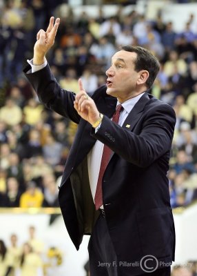 Duke Blue Devils Head Coach Mike Krzyzewski signals a defensive set to his team