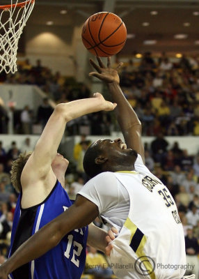 Georgia Tech F Zachery Peacock gets shoved in the back by Duke F Kyle Singler as he attempts to pull down a rebound