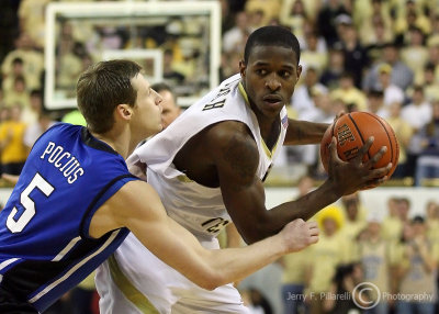 Georgia Tech G Clinch looks to drive as he is harassed by Duke G Pocius