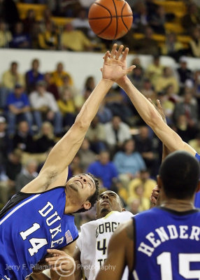 Jackets F Aminu is boxed out by Blue Devils F McClure in the fight over a rebound