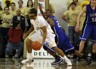 Tech G Miller dribbles around Duke G Smith on his way to the basket