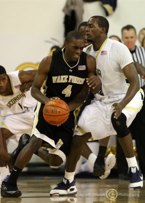 Yellow Jackets F Peacock stands his ground on defense as Demon Deacons G Harvey Hale drives to the basket