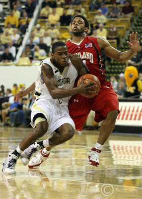 Georgia Tech G Clinch makes a move while Maryland G Mosley attempts to cut him off