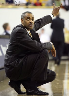 Georgia Tech Yellow Jackets Head Coach Paul Hewitt signals to his team while checking the game clock