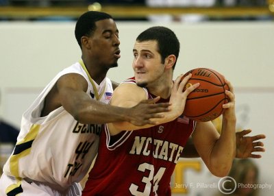 Georgia Tech F Alade Aminu uses smothering defense on N.C. State C Ben McCauley