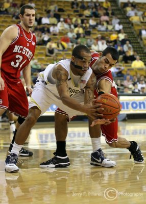 Georgia Tech G Miller fights for a loose ball with N.C. State G Gonzalez