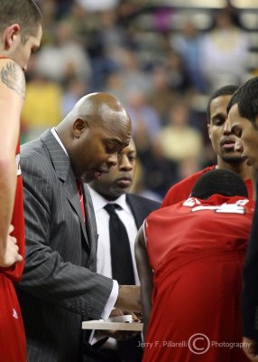 North Carolina State Wolfpack Head Coach Sidney Lowe draws up a play during a thirty-second timeout